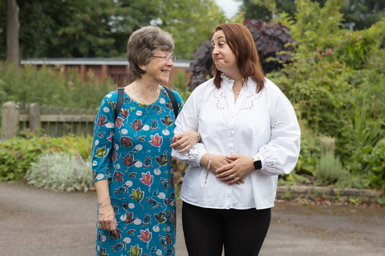 Client and CareGiver Walking Down a Garden 