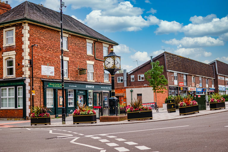Shifnal town centre with clock tower and local shops in Shropshire