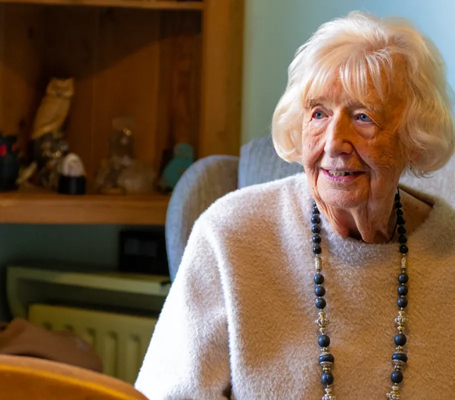 Client receiving round-the-clock care at home with a dedicated Carer nearby.