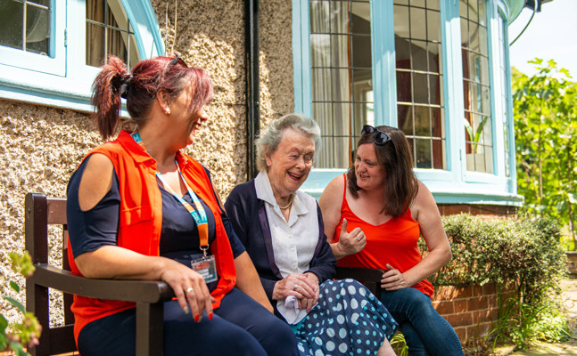 CareGivers and client talking on a bench