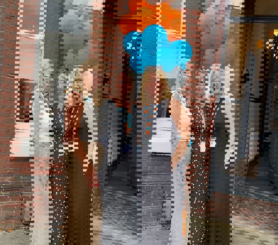 Ali, Yasmin, and Leighann smiling and posing in front of the door during the opening of the new Right at Home Southampton office.