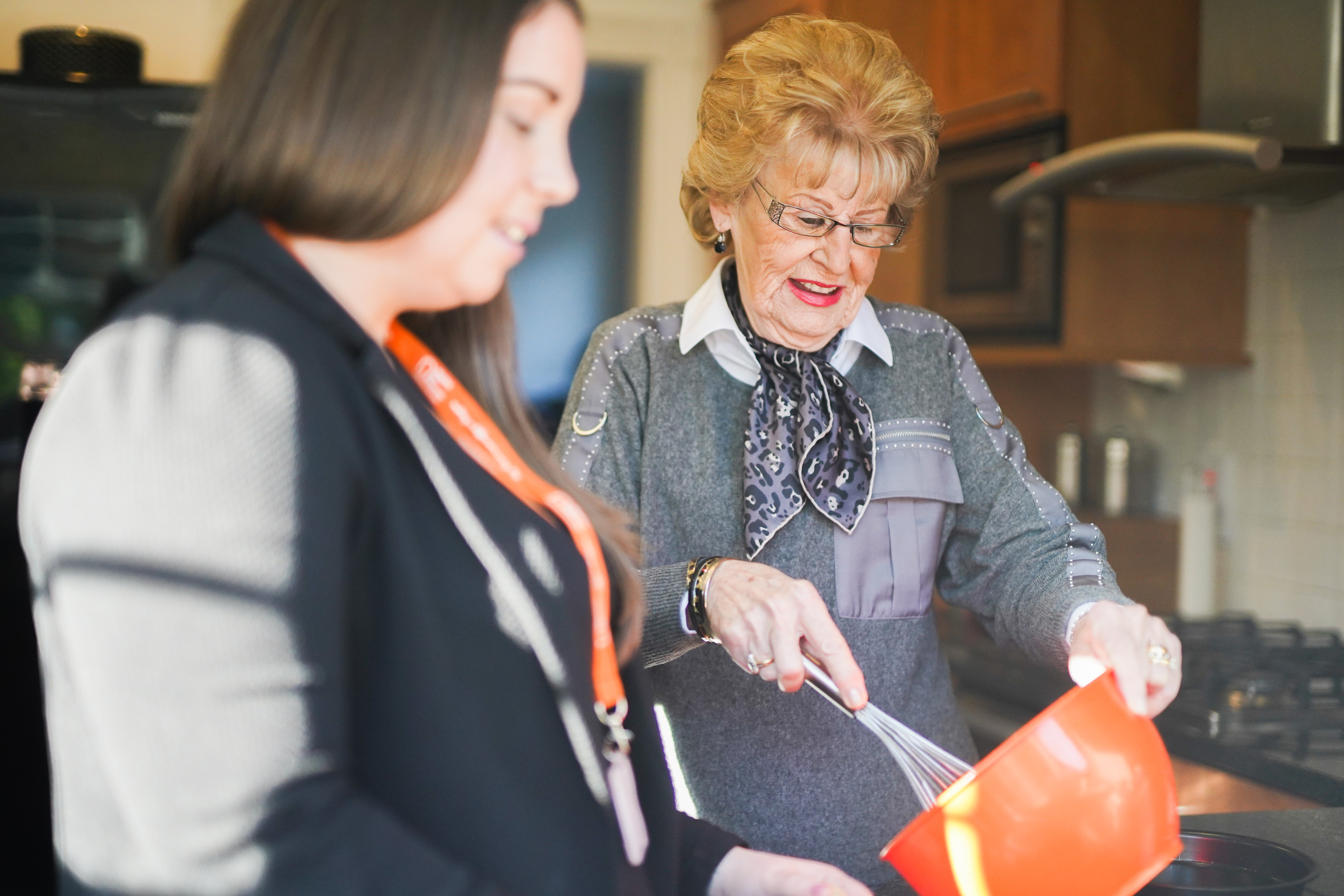 Caregiver baking with live-in homecare Client