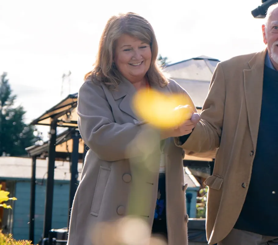 A client enjoying time outdoors with support from their carer