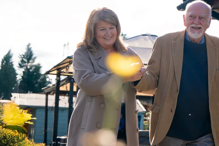A client enjoying time outdoors with support from their carer