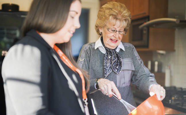 Client and CareGiver Baking in Kitchen
