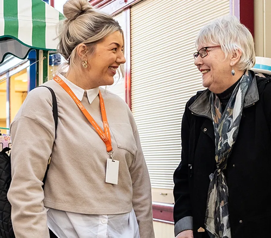 Client and Carer strolling through the local market 