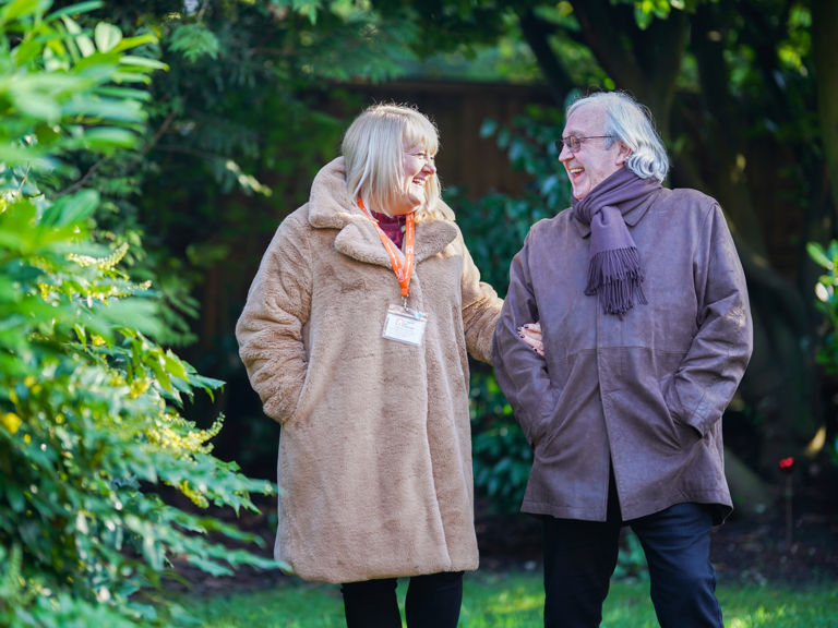 Caregiver and client outside smiling