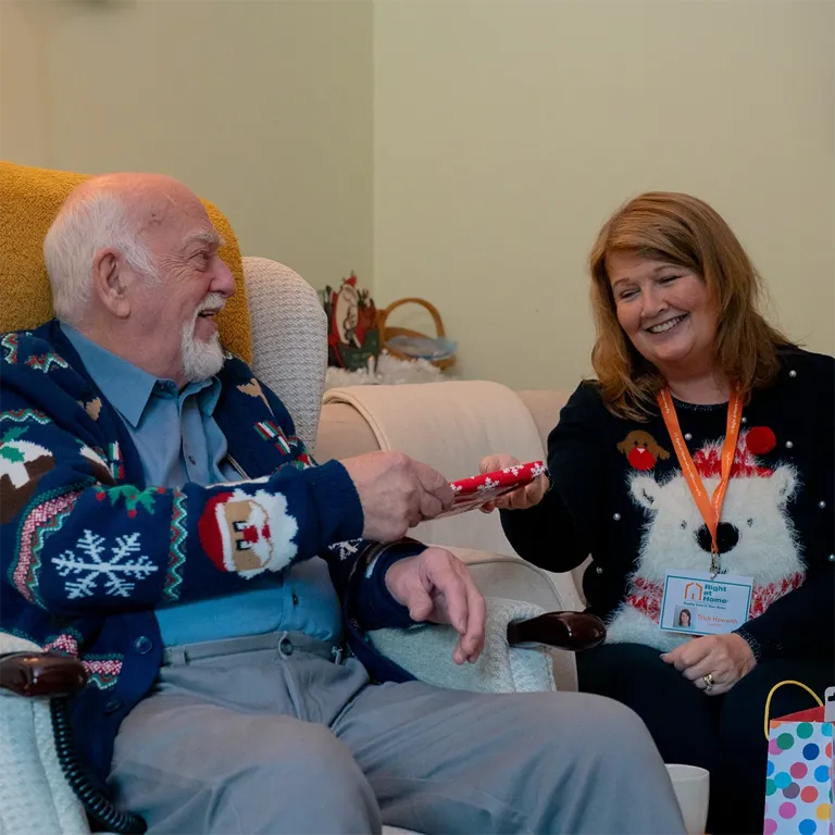 Client receiving small gift at Christmas from Carer