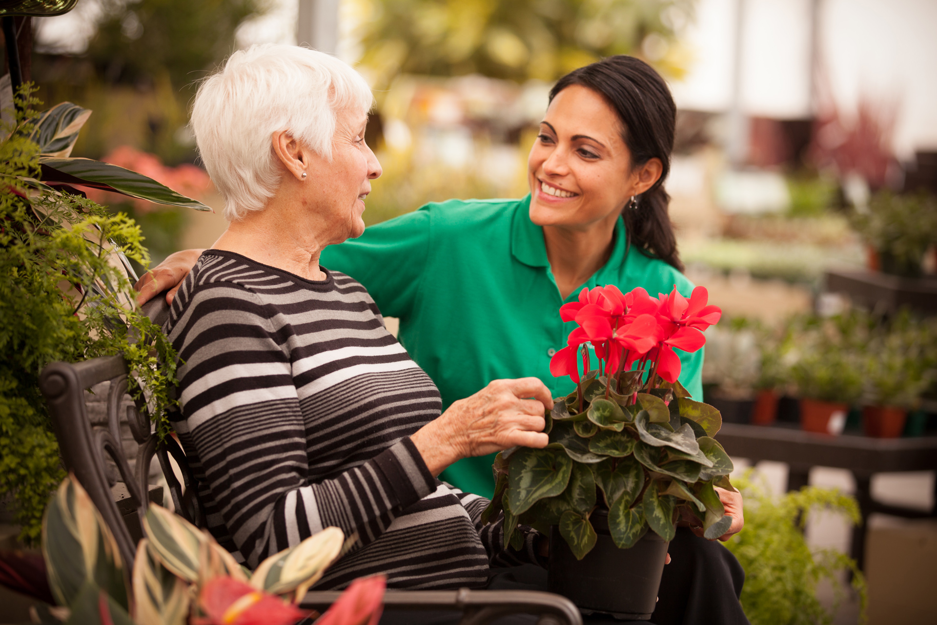 caregiver supporting client at a garden centre