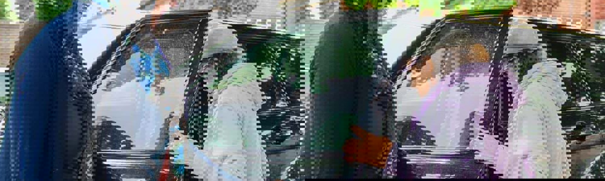 Client being helping into car by CareGiver