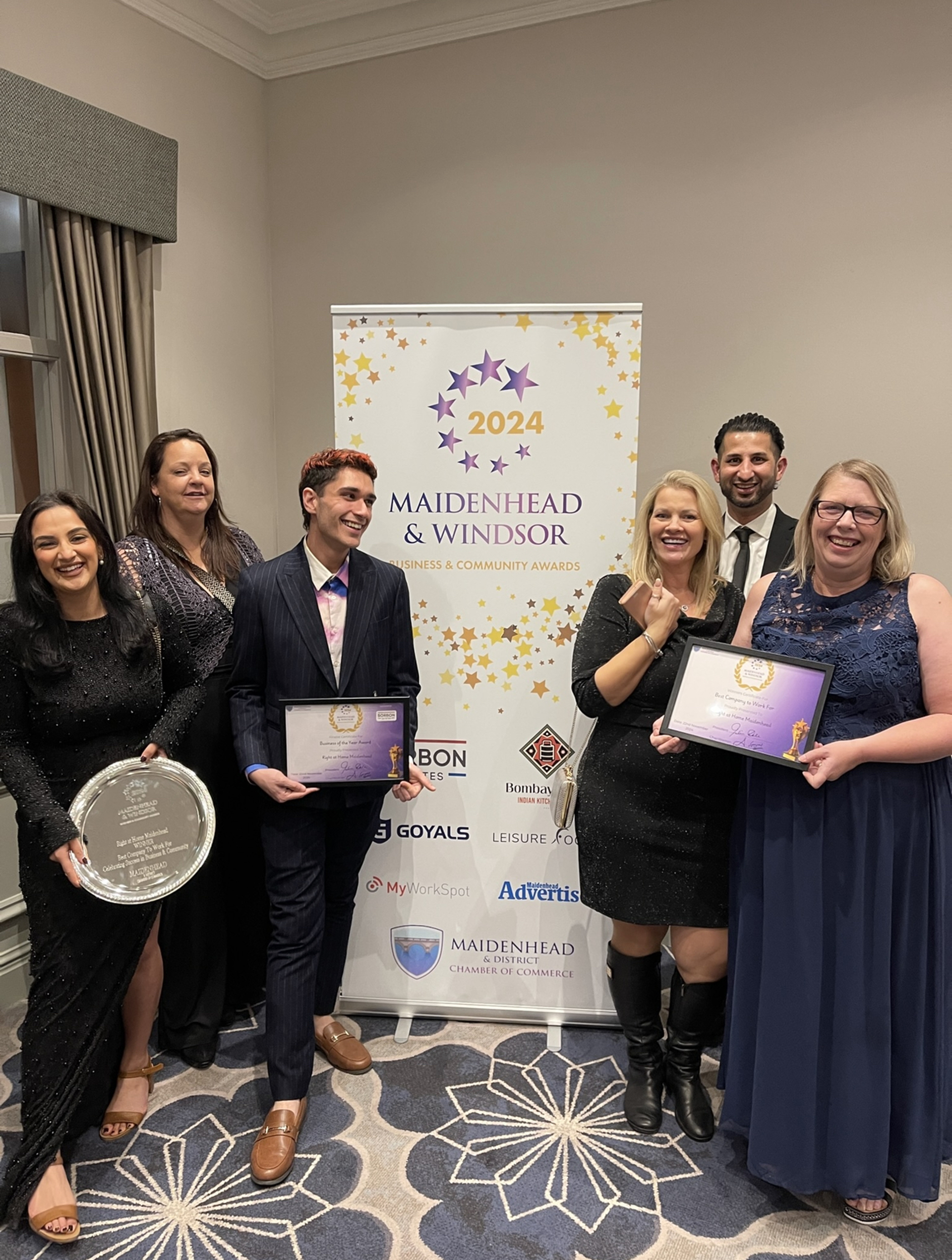 Right at Home Team standing with their award for Best Company To Work For 2024