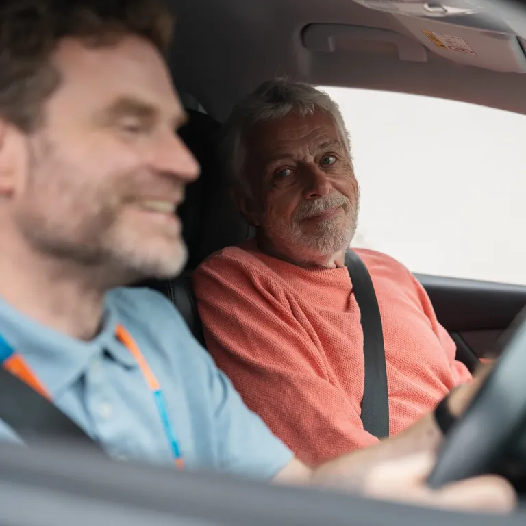 Client living with Dementia enjoying a drive out with their Carer