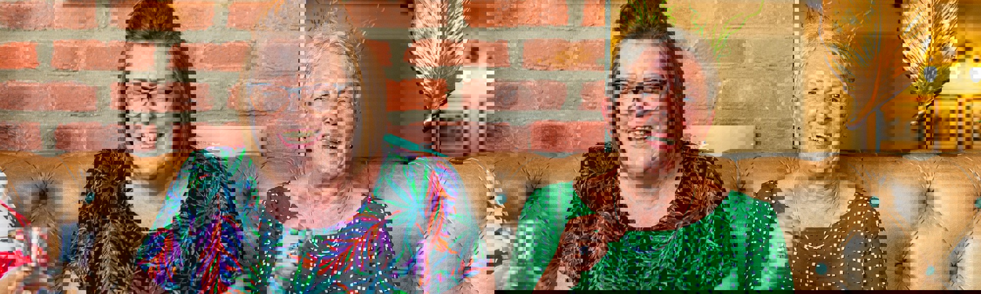 CareGiver and client in café eating cake and laughing