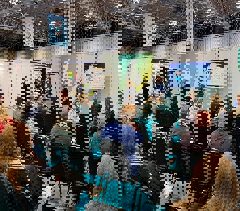 joe speaks to audience at franchise show