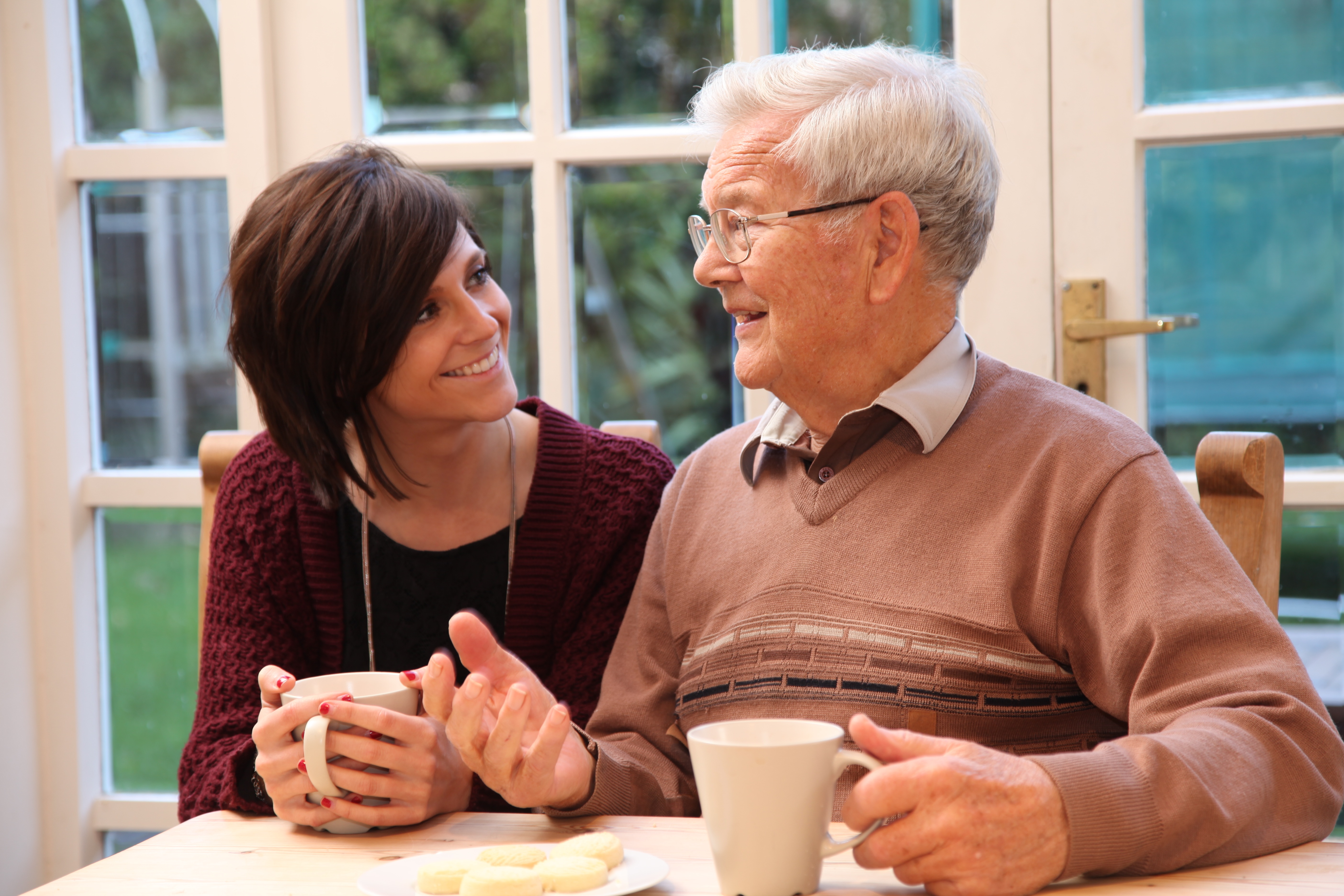 Female Caregiver Drinking Tea With Male Client