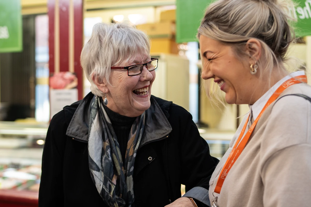 Carer and Client enjoying a trip to the local market