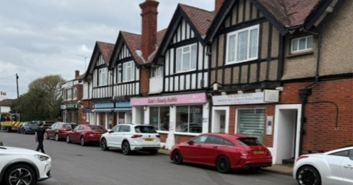 Street scene in Warsash with parked cars and local buildings, showing the village atmosphere.