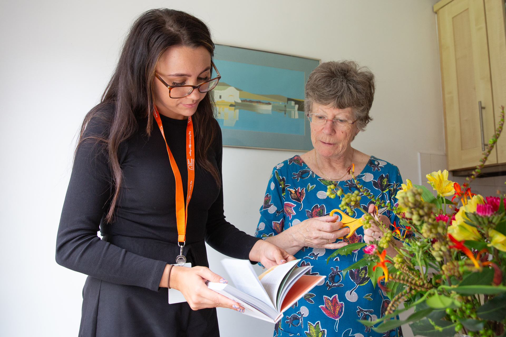 client trimming flowers with homecare caregiver