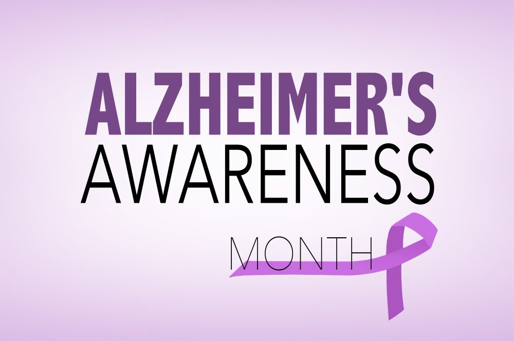 'Alzheimer's Awareness Month' sign with a purple background and a purple ribbon