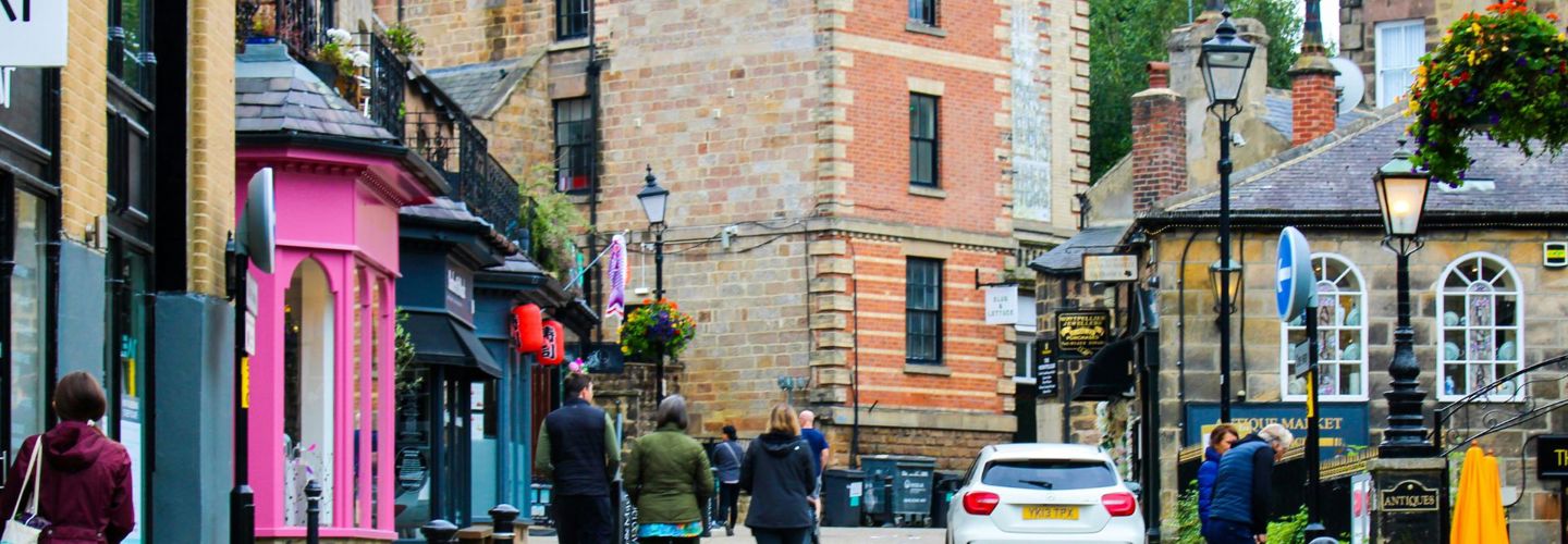 town street in harrogate with people, shops and cars