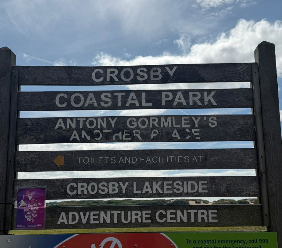 Sign post of locations around Crosby Beach