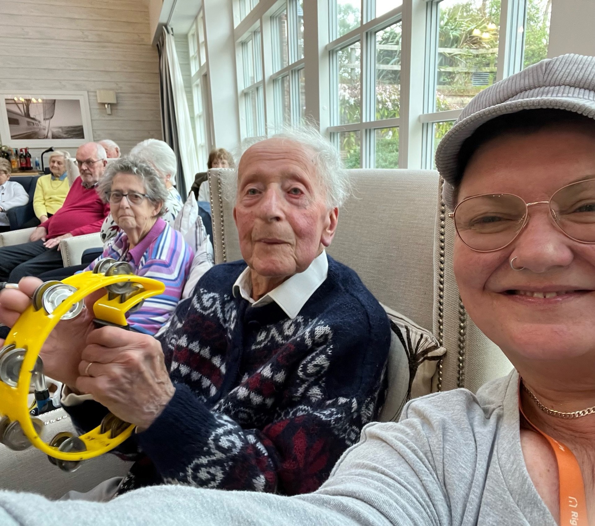 Caregiver with client playing the tamborine