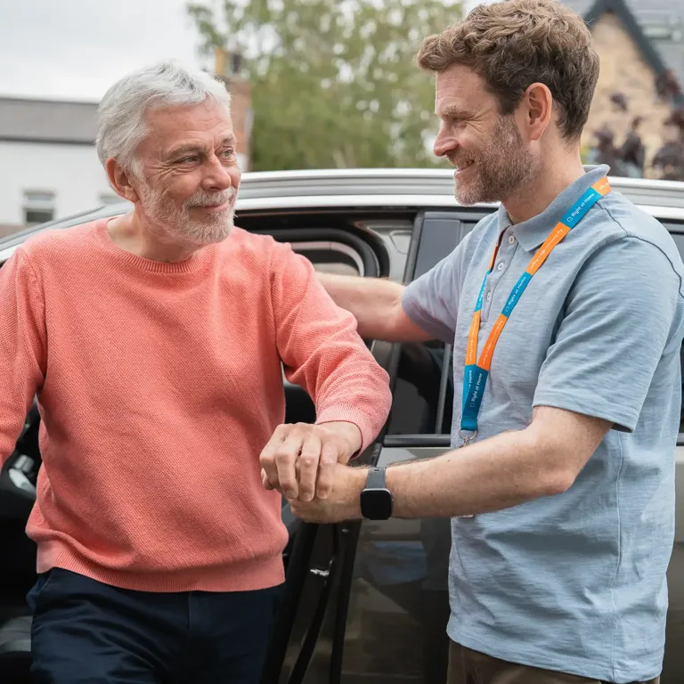 Carer supporting Client who is living with Dementia to exit a car safely