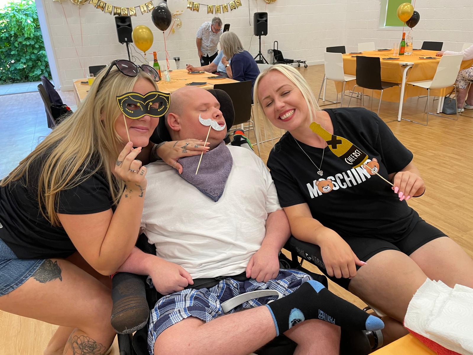 Care staff and clients with photo props