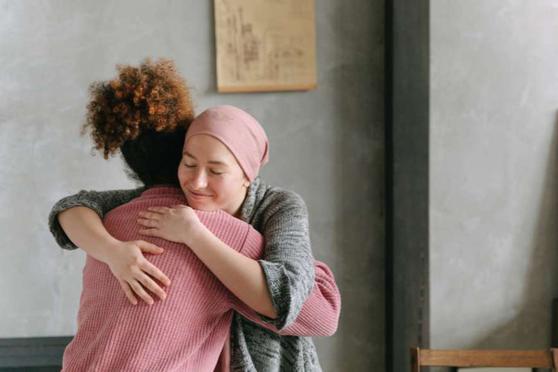 young-female-cancer-patient-being-comforted-at-home-by-a-female-home-carer-from-right-at-home-cheshire-east