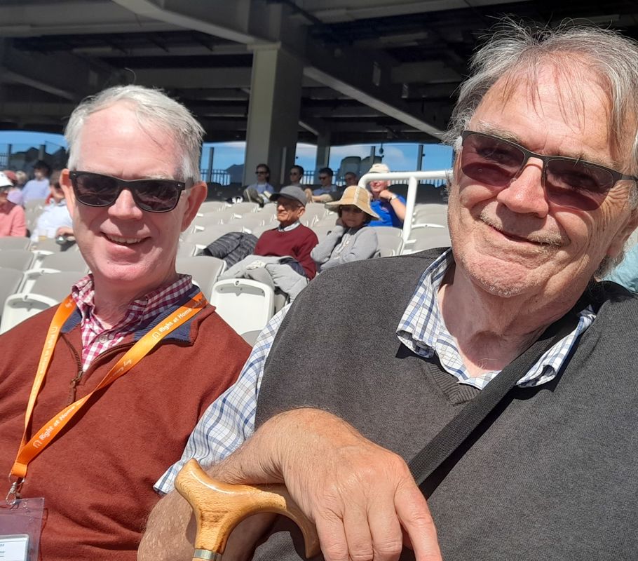 client and franchise owner smiling watching cricket