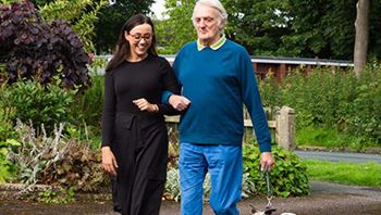 Post Stroke Client Walking With CareGiver