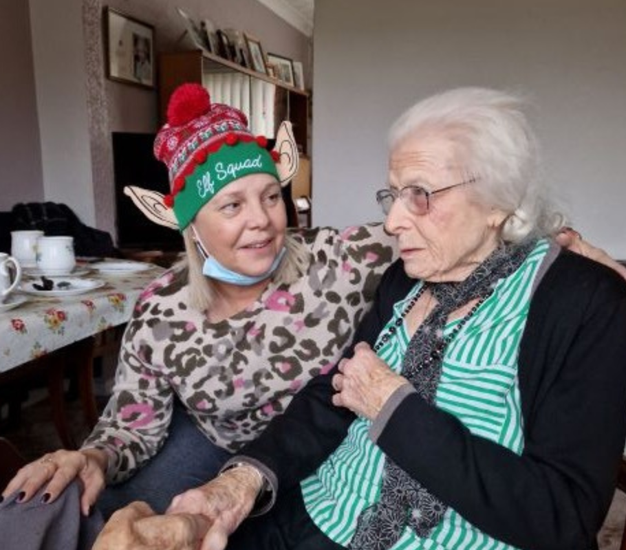 Caregiver and homecare client enjoying Christmas celebrations