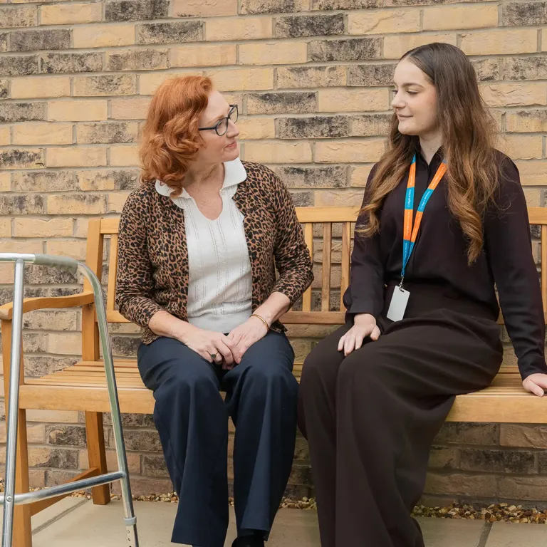 Client and Carer enjoying a conversation in the garden 