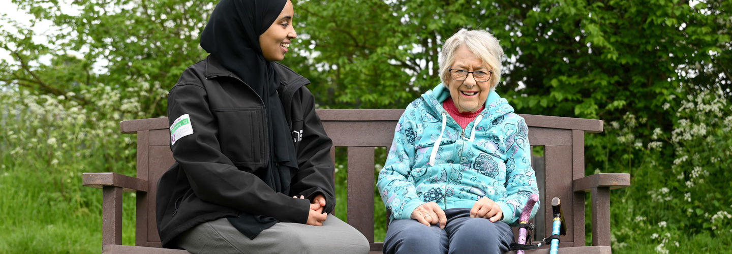 Elderly_Client_Sitting_With_CareGiver_Outside