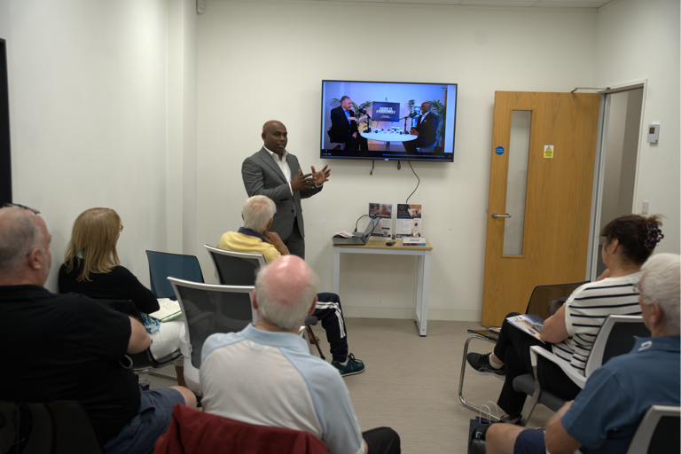 Attendees listening to a presentation during Xcel Health's Living Well with Arthritis workshop.