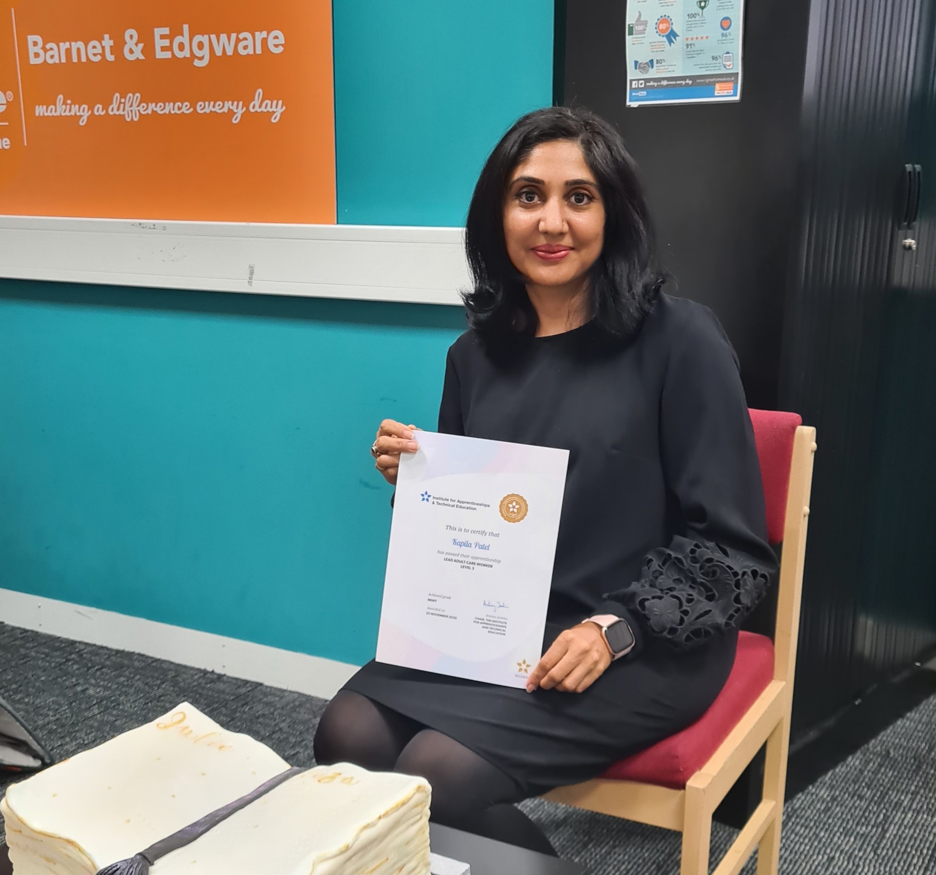 caregiver sitting with nvq award certificate
