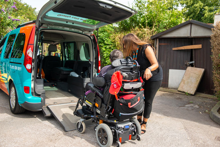 Client and Carer using mobility vehicle 