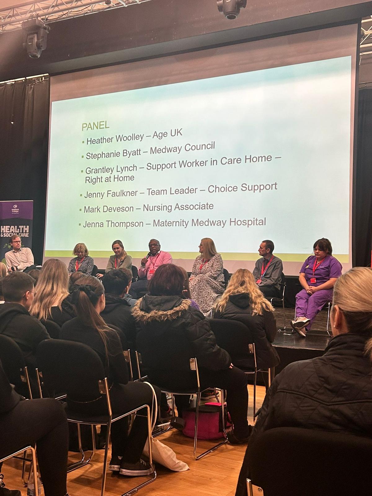 MD on stage giving a speech to aspiring students