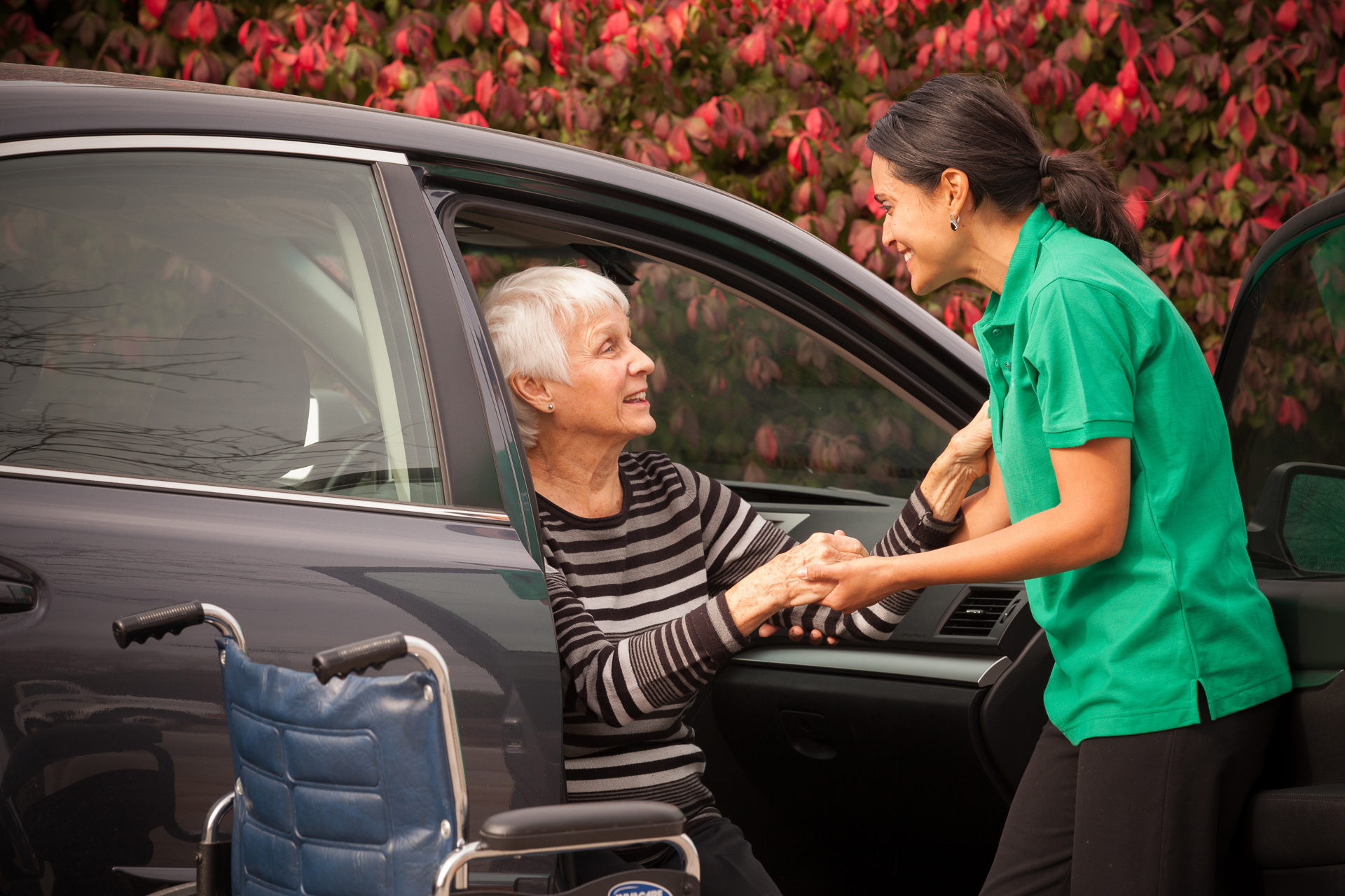 caregiver helping client out of car