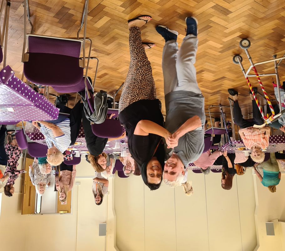 caregiver and client dancing at community event