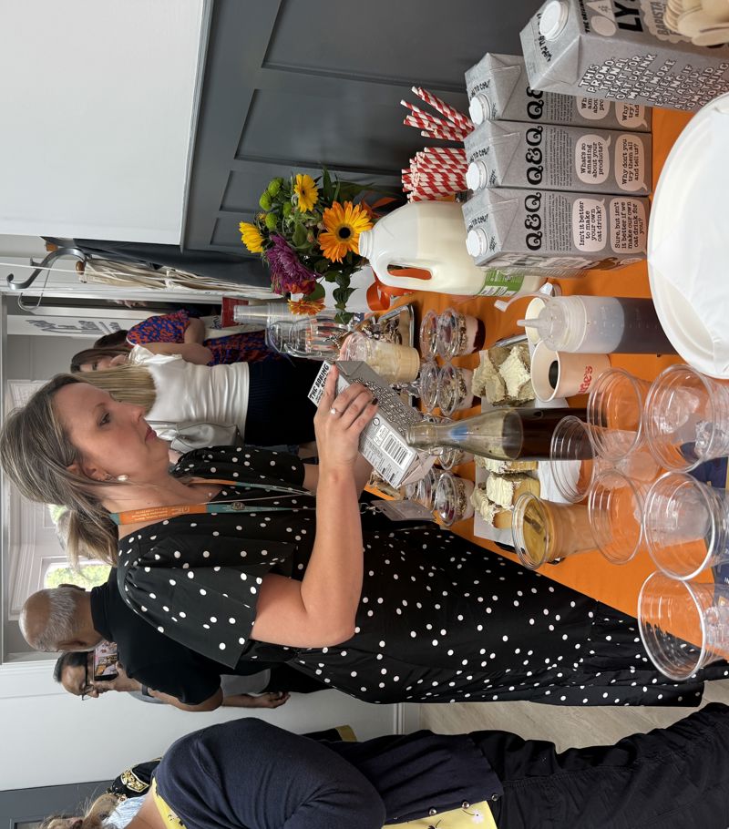 Yasmin, client care manager, preparing an oat drink in a glass during the opening of the new Right at Home Southampton office.