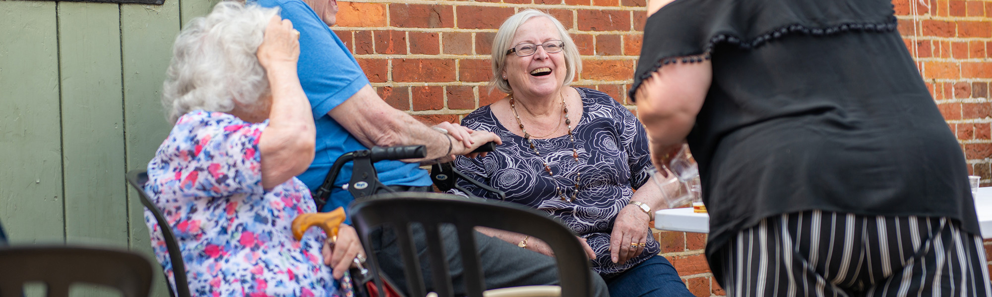 Clients and CareGivers sitting at a table outside
