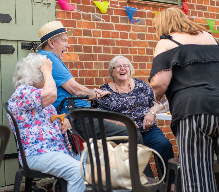 Clients and CareGivers sitting at a table outside