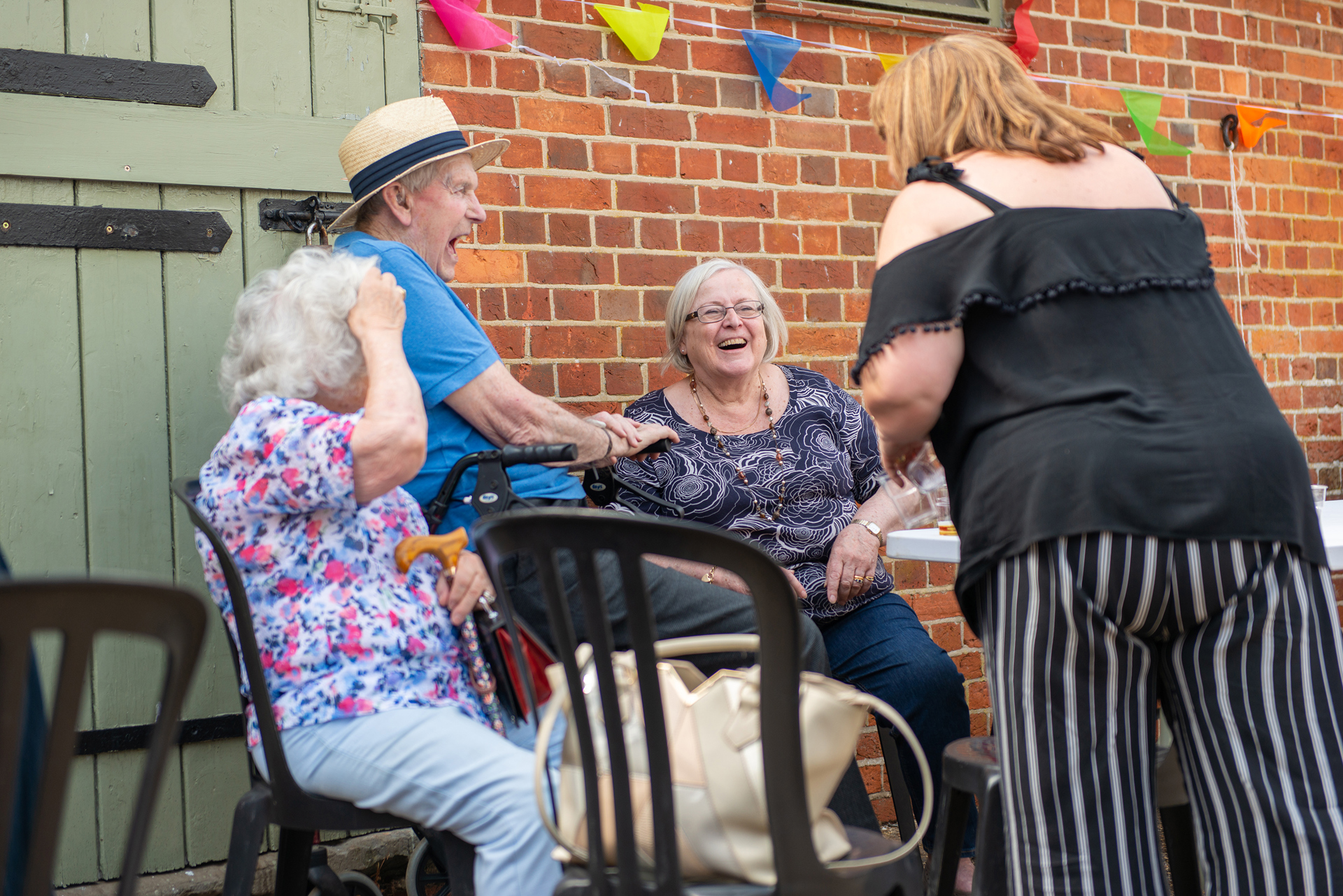 Clients and CareGivers sitting at a table outside