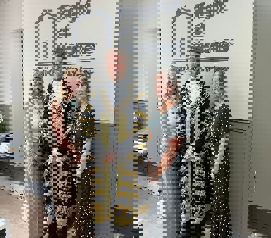 Lord Mayor James Baillie smiling in the center with Ali T, office manager, and Yasmin, client care manager, during the Right at Home Southampton office event.