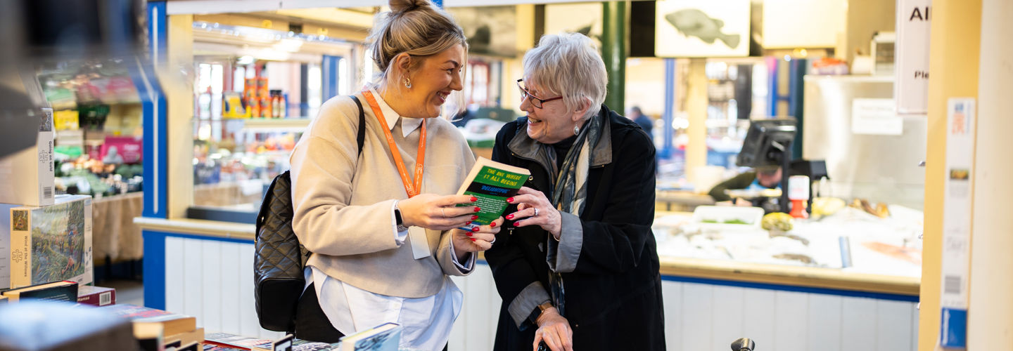 Client and Carer book shopping together