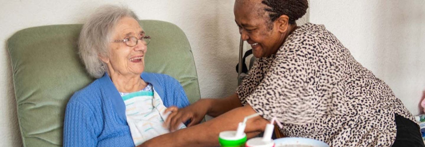 Elderly woman receiving care from caregiver