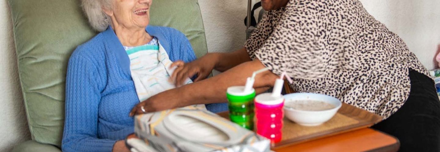 Elderly woman receiving care from caregiver