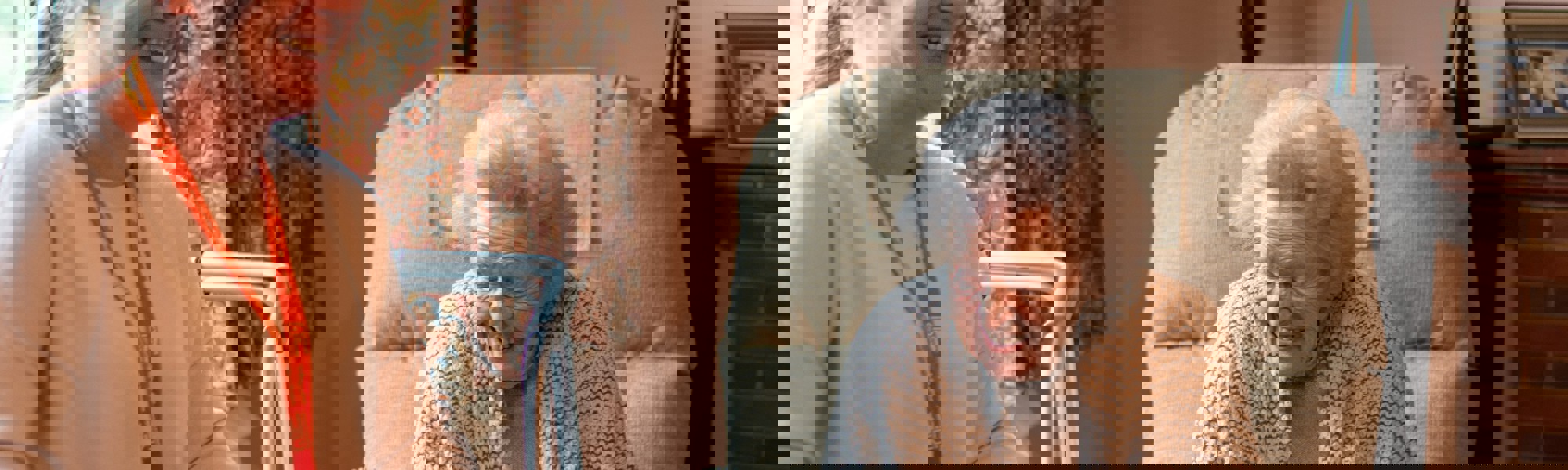 Elderly Client and Carer laughing together