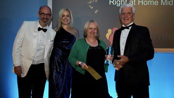 Lou Berreen is awarded CareGiver of the Year by Neil Eastwood, CEO of Care Friends